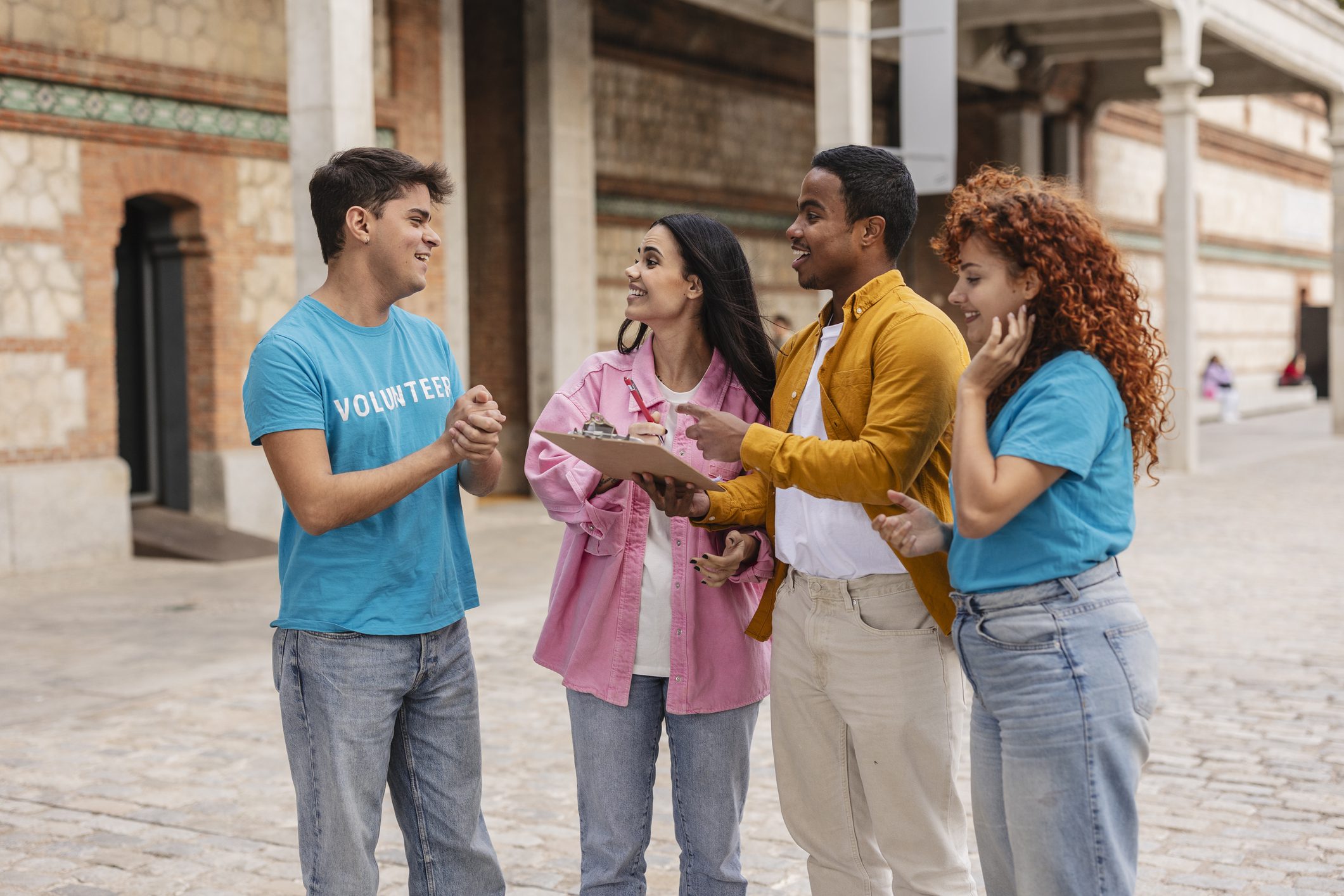 Group of volunteers talking outside building