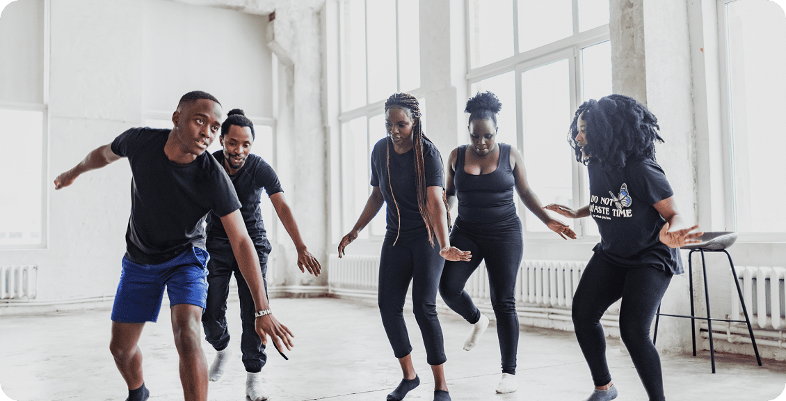 Friends practicing dance moves indoors