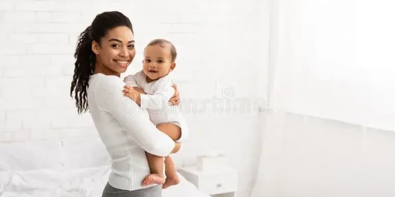 Joyful parent and baby in bright room