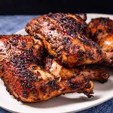 Grilled seasoned chicken thighs on plate